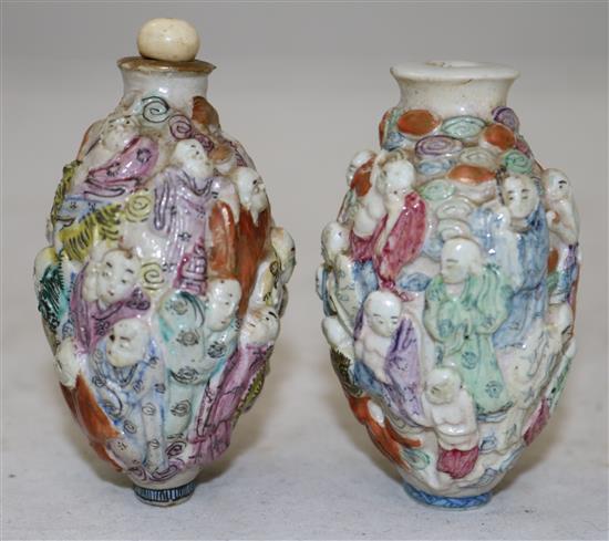 Two Chinese moulded famille rose eighteen luohan snuff bottles, Qianlong marks, but 1821-50, height 7.2cm, one with rim chips